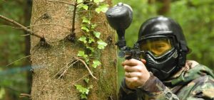 Male in army uniform holding a paintball gun