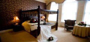 Bedroom with brides dress on the bed