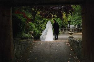 bride and groom walking in the gardens