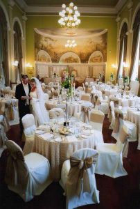 Bride and Groom standing around the tables and chairs