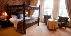 Queen size bedroom with a round table and 2 chairs