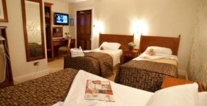 3 beds with brown and white bedding