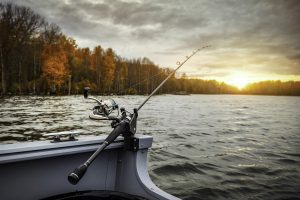 Boat on the river with a fishing rod