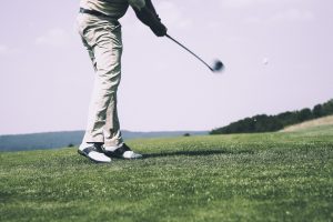 Male taking a swing with the golf club