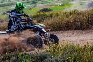 Male quad biking on gravel road