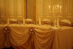 Wedding table decorated with flower bows and candles