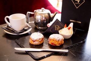 Tea and biscuits setting with a menu