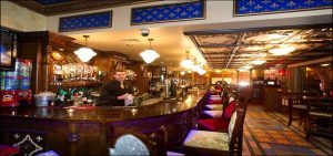 Barmen cleaning a glass behind the bar counter