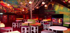 Outside smoking area with table and chairs and a tree in the middle